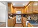 Well-equipped kitchen with wood cabinets, white appliances, and tile floor at 2236 Bailey Dr, North Charleston, SC 29405