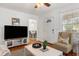 Bright living room with hardwood floors, a large TV, and comfy seating at 2236 Bailey Dr, North Charleston, SC 29405