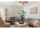 Cozy living room featuring two sofas, a coffee table, and large windows at 2236 Bailey Dr, North Charleston, SC 29405