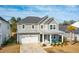 Two-story house, gray siding, metal roof, turquoise chairs at 230 Granton Edge Ln, Summerville, SC 29486