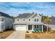 Two-story house, gray siding, metal roof, turquoise chairs at 230 Granton Edge Ln, Summerville, SC 29486