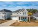 Two-story house, gray siding, metal roof, turquoise chairs at 230 Granton Edge Ln, Summerville, SC 29486