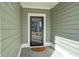 Front entrance with black storm door and welcome mat at 230 Granton Edge Ln, Summerville, SC 29486