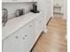 White kitchen cabinets and quartz countertops offer ample storage space at 230 Granton Edge Ln, Summerville, SC 29486