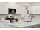 Modern kitchen with white cabinets, stainless steel appliances and a quartz countertop at 230 Granton Edge Ln, Summerville, SC 29486