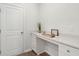 Bright laundry room with white cabinets and quartz countertop at 230 Granton Edge Ln, Summerville, SC 29486