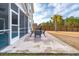 Spacious patio with seating area, adjacent to screened porch at 230 Granton Edge Ln, Summerville, SC 29486
