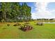 Scenic picnic area with tables and grills near a pond at 253 Pine Crest View Dr, Summerville, SC 29486