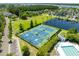 Aerial view of tennis and basketball courts with lush green landscaping and pond at 2912 Rivertowne Pkwy, Mount Pleasant, SC 29466