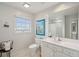 Clean bathroom boasts a white vanity, toilet, and shower at 3019 Brownell Ave, Sullivans Island, SC 29482