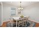 Bright dining room with white table and chairs, hardwood floors, and decorative rug at 3019 Brownell Ave, Sullivans Island, SC 29482