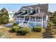 Two-story home with gray siding, white trim, and a wraparound porch at 3019 Brownell Ave, Sullivans Island, SC 29482