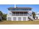 Back of house featuring gray siding, large screened porch, and deck at 3019 Brownell Ave, Sullivans Island, SC 29482