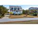 Two-story home exterior with gray siding, front porch, and palm trees at 3019 Brownell Ave, Sullivans Island, SC 29482