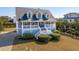 Two-story home with gray siding, white trim, and a wraparound porch at 3019 Brownell Ave, Sullivans Island, SC 29482