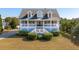 Two-story home with gray siding, white trim, and a wraparound porch at 3019 Brownell Ave, Sullivans Island, SC 29482