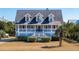 Two-story home exterior with gray siding, white trim, and front porch at 3019 Brownell Ave, Sullivans Island, SC 29482