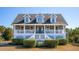 Two-story house with gray siding, white trim, and a wraparound porch at 3019 Brownell Ave, Sullivans Island, SC 29482