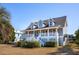 Two-story house with gray siding, white trim, and a wraparound porch, side view at 3019 Brownell Ave, Sullivans Island, SC 29482