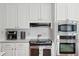 White kitchen with stainless steel appliances and ample counter space at 3019 Brownell Ave, Sullivans Island, SC 29482