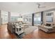 Spacious living room with hardwood floors, comfortable seating, and access to a balcony at 3019 Brownell Ave, Sullivans Island, SC 29482