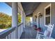 Spacious front porch with white columns, rocking chairs, and calming view at 3019 Brownell Ave, Sullivans Island, SC 29482