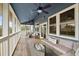 Spacious screened porch with multiple seating areas and ceiling fans at 3019 Brownell Ave, Sullivans Island, SC 29482