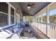 Relaxing screened porch with wicker furniture and ceiling fans at 3019 Brownell Ave, Sullivans Island, SC 29482