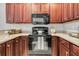 Well-equipped kitchen featuring dark wood cabinets and black appliances at 3038 Fraserburgh Way # 2200, Mount Pleasant, SC 29466