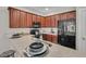 Stylish kitchen with dark wood cabinets, granite countertops and black appliances at 3038 Fraserburgh Way # 2200, Mount Pleasant, SC 29466