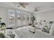 Bright living room with white sofas, large windows, and access to a balcony at 3038 Fraserburgh Way # 2200, Mount Pleasant, SC 29466