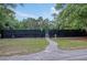 Tennis courts with surrounding trees and a paved path, highlighting recreational amenities at 3038 Fraserburgh Way # 2200, Mount Pleasant, SC 29466