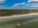 Stunning aerial of beach homes, showcasing ocean views at 367 Pelican Flight Dr, Dewees Island, SC 29451