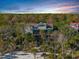 Beachfront home with a large deck and screened porch, surrounded by lush greenery at 367 Pelican Flight Dr, Dewees Island, SC 29451