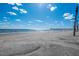 Sandy beach with ocean and blue sky at 367 Pelican Flight Dr, Dewees Island, SC 29451