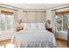 Bright bedroom with a king-size bed and hardwood floors at 367 Pelican Flight Dr, Dewees Island, SC 29451