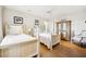 Charming bedroom with twin beds, hardwood floors, and plenty of natural light at 367 Pelican Flight Dr, Dewees Island, SC 29451