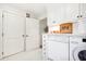 Clean laundry room with washer, dryer, and well-organized storage at 367 Pelican Flight Dr, Dewees Island, SC 29451