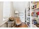 Cozy library with built-in bookshelves and comfortable armchair at 367 Pelican Flight Dr, Dewees Island, SC 29451