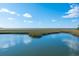 Picturesque marsh views with calm water reflecting the sky at 367 Pelican Flight Dr, Dewees Island, SC 29451