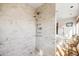 Large walk-in shower with beige tile and multiple shower heads at 367 Pelican Flight Dr, Dewees Island, SC 29451