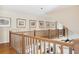 Upper hallway with hardwood floors and a wooden railing at 367 Pelican Flight Dr, Dewees Island, SC 29451