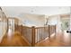 Hardwood floors and wooden railings in an upper hallway at 367 Pelican Flight Dr, Dewees Island, SC 29451
