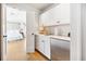 Convenient wet bar with a mini-fridge and white cabinetry at 367 Pelican Flight Dr, Dewees Island, SC 29451