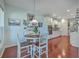 Open kitchen with white cabinets, stainless steel appliances, and a breakfast bar at 369 Waterlily Way, Summerville, SC 29486