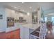 Modern kitchen with white cabinets, stainless steel appliances, and an island with seating at 369 Waterlily Way, Summerville, SC 29486
