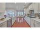 Bright kitchen with white cabinets, stainless steel appliances, and hardwood floors at 369 Waterlily Way, Summerville, SC 29486