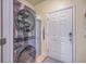 Laundry room with stacked LG washer and dryer, cabinet storage, and tile floor at 369 Waterlily Way, Summerville, SC 29486