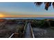 Wooden walkway to the beach at sunrise at 403 W West Ashley Ave, Folly Beach, SC 29439