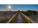Wooden boardwalk leads to beach with ocean view at 403 W West Ashley Ave, Folly Beach, SC 29439